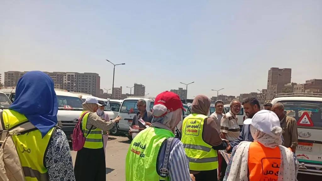 a group of women standing next to a red van